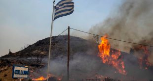 Flames burn a hill on the Aegean Sea island of Rhodes, southeastern Greece, on Monday, July 24, 2023. (AP Photo/Petros Giannakouris).