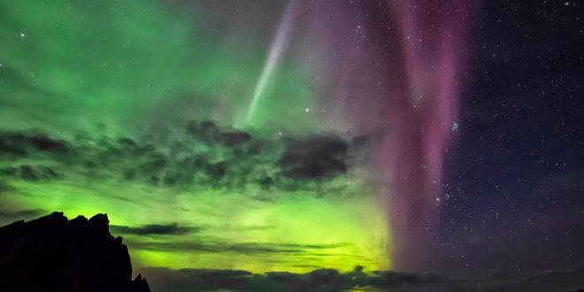 First place in the 2021 IAU OAE Astrophotography Contest, category Aurorae (still images): Multicolored aurora in Iceland, by Marco Migliardi on behalf of Associazione Astronomica Cortina, Italy. Aurorae are the result of ionisation and excitation processes in Earth's upper atmosphere, caused by charged particles from the solar wind or from coronal mass ejections. The different colours in an aurora display indicate the species of atmospheric atoms and molecules involved. The most common colour is a bright green, which, together with deep red, originates from atomic oxygen. Blue, purple and pink hues are much rarer and originate from molecular nitrogen. The reflection of the aurora in the water indicates the brightness of intense aurorae at higher latitudes. Link:  See image in Zenodo